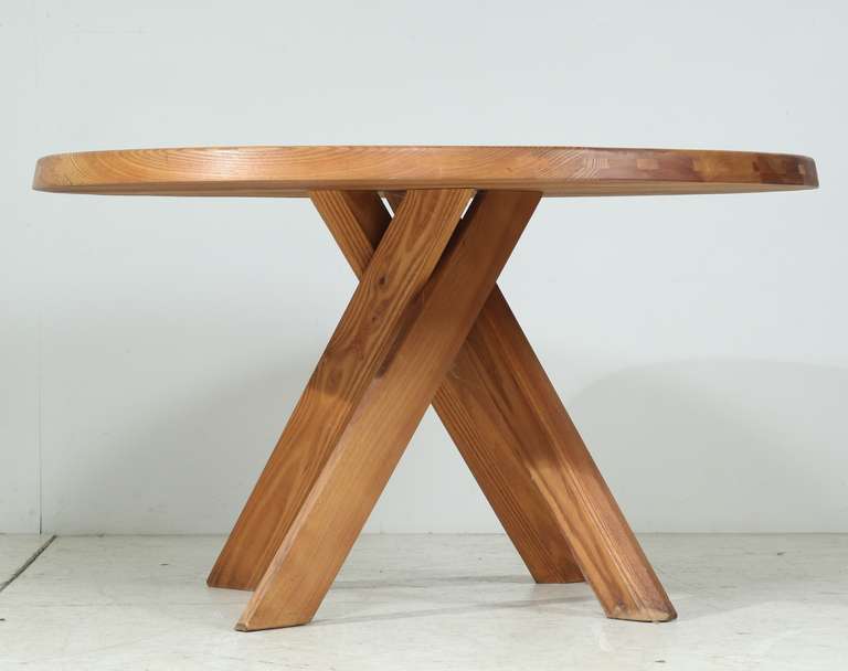 A round 'SFAX' dinnertable   by Pierre Chapo .
The model 'T21 B' table stands on four crossed legs, typical for Chapo's designs.