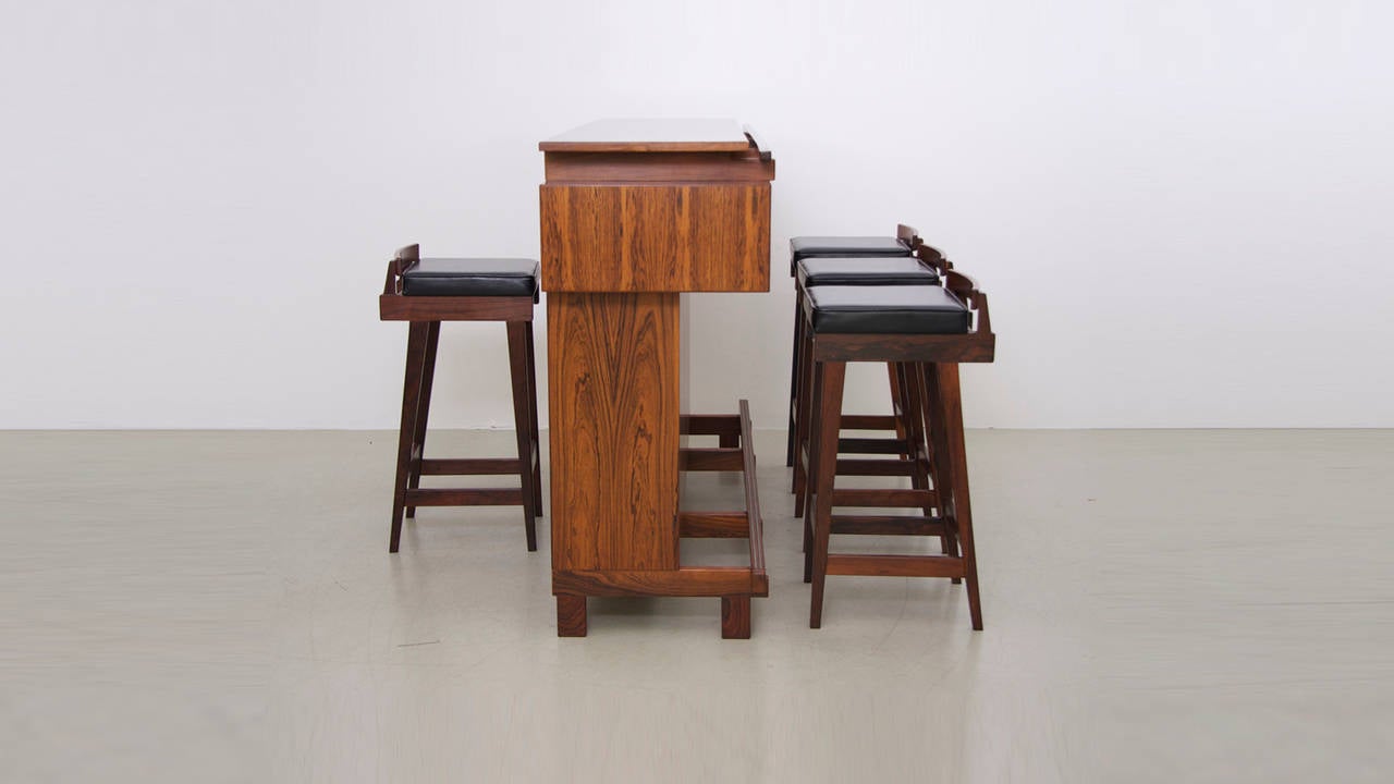 Danish modern rosewood master bar with four Erik Buck bar stools for Dyrlund in excellent condition.
This set is very well made and has beautiful details. An absolutely stunning set when seen in real life.