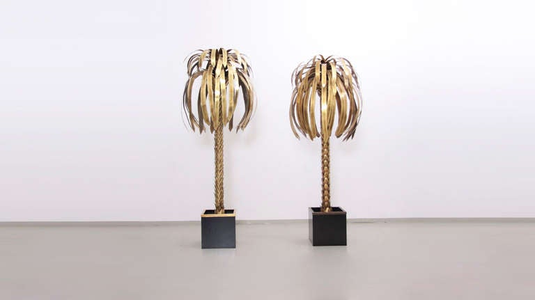 Pair of palm tree floor lamps by Maison Jansen. Beautifully designed palm trunk and fronds skillfully crafted from hand-cut, welded sheet metal with a polished brass finish. Each lamp has three E27 recessed light sockets in the middle of the