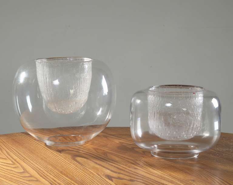 A pair of glass bowls by Timo Sarpaneva for Iittala, Finland. Smooth glass on the outside and ice glass on the inside. These pieces are original Finn Form stock from the 1960s and never used, with labels and in perfect condition. Marked by Sarpaneva