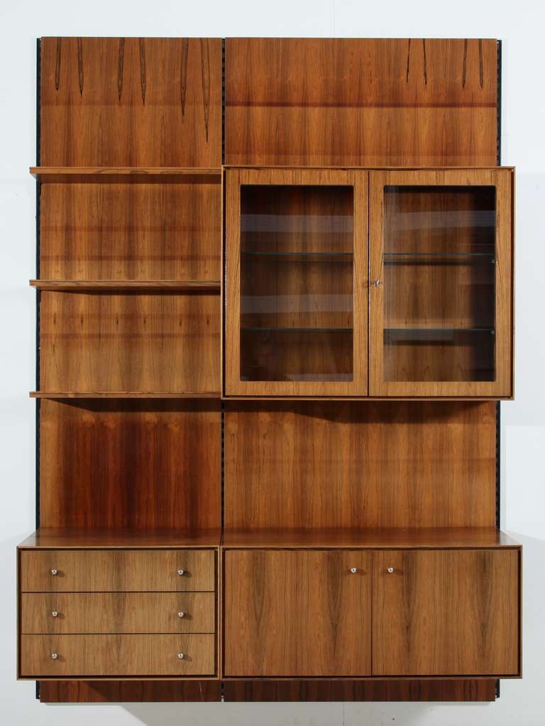 Rosewood wall unit with a double cupboaurd, a glass vitrine and chest of drawers and shlves.