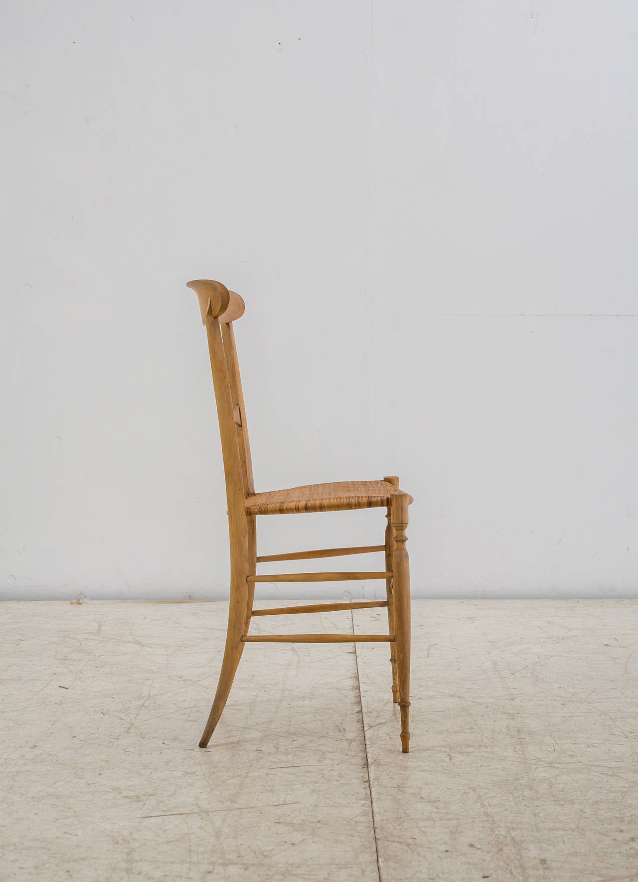 An elegant model Campanino chair by Chiavari, made of a turned beech frame with a cane seating.
This slim and light chair was originally created in 1807 by Giuseppe Gaetano Descalzi and was the inspiration for Gio Ponti's (super) leggera chair.