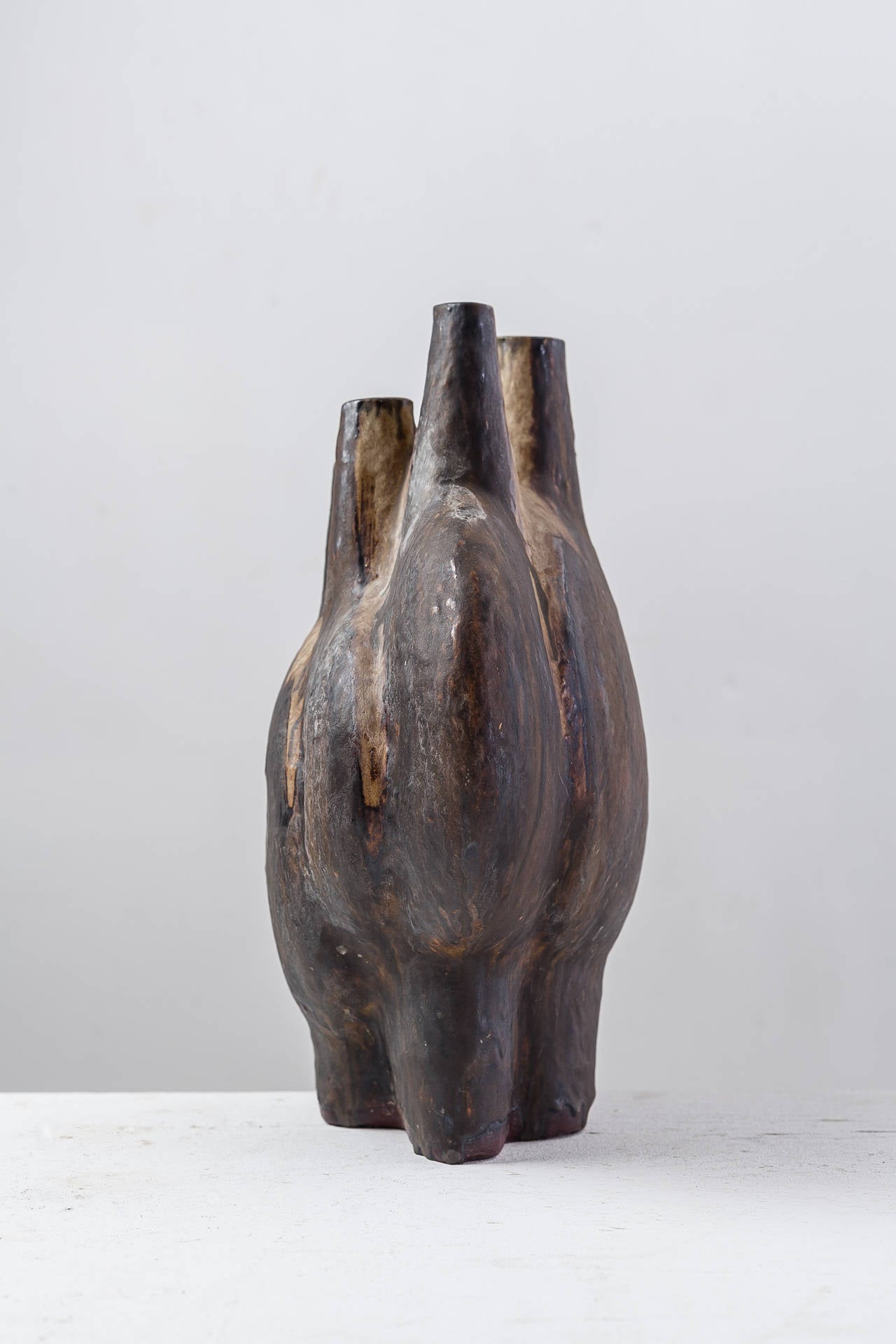 A sculptural, organically shaped, glazed ceramic vase with five openings, from Germany.