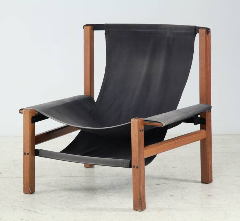 Fantastic and sober designed chair by Dick Lookman  .
Heavy teak frame with a wonderful heavy sailcloth slingseat that is held in place with metal parts. The armrests run from small at the back to wide on the front. 

These armchairs were