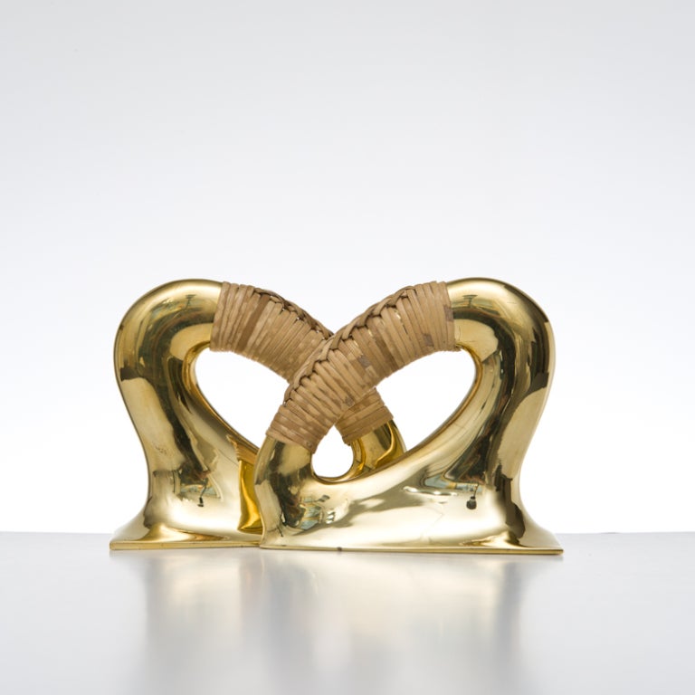 Classic pair of Carl Auböck bookends in polished brass and coiled with cane.