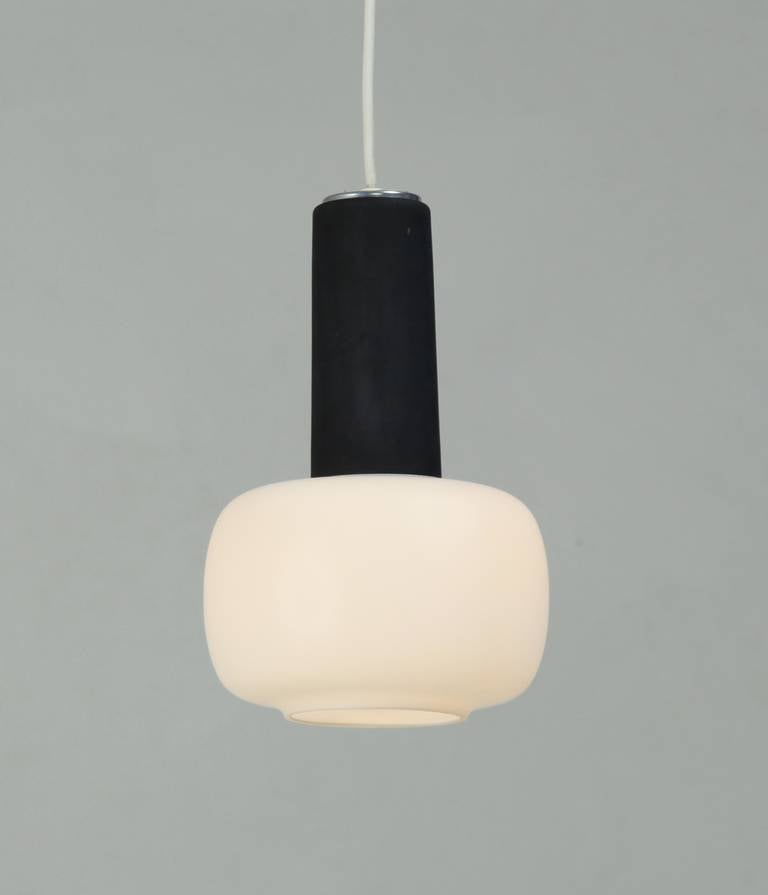 A set of three black and opaline white pendant lamps by Finnish designer Helena Tynell for the German company Glashütte Limburg. Both the white and black elements are in glass.
Published in Suomalaisia Valaisimia, pages 102-103.