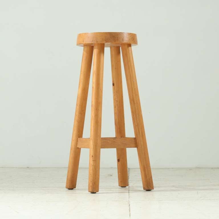 A high, wooden bar stool by Charlotte Perriand. This stool was designed for the chalet-hotel Le Doron in the French ski resort Méribel Les Allues, built (1946-48) by architects Paul Grillo and Christian Durupt and furnished by Perriand.