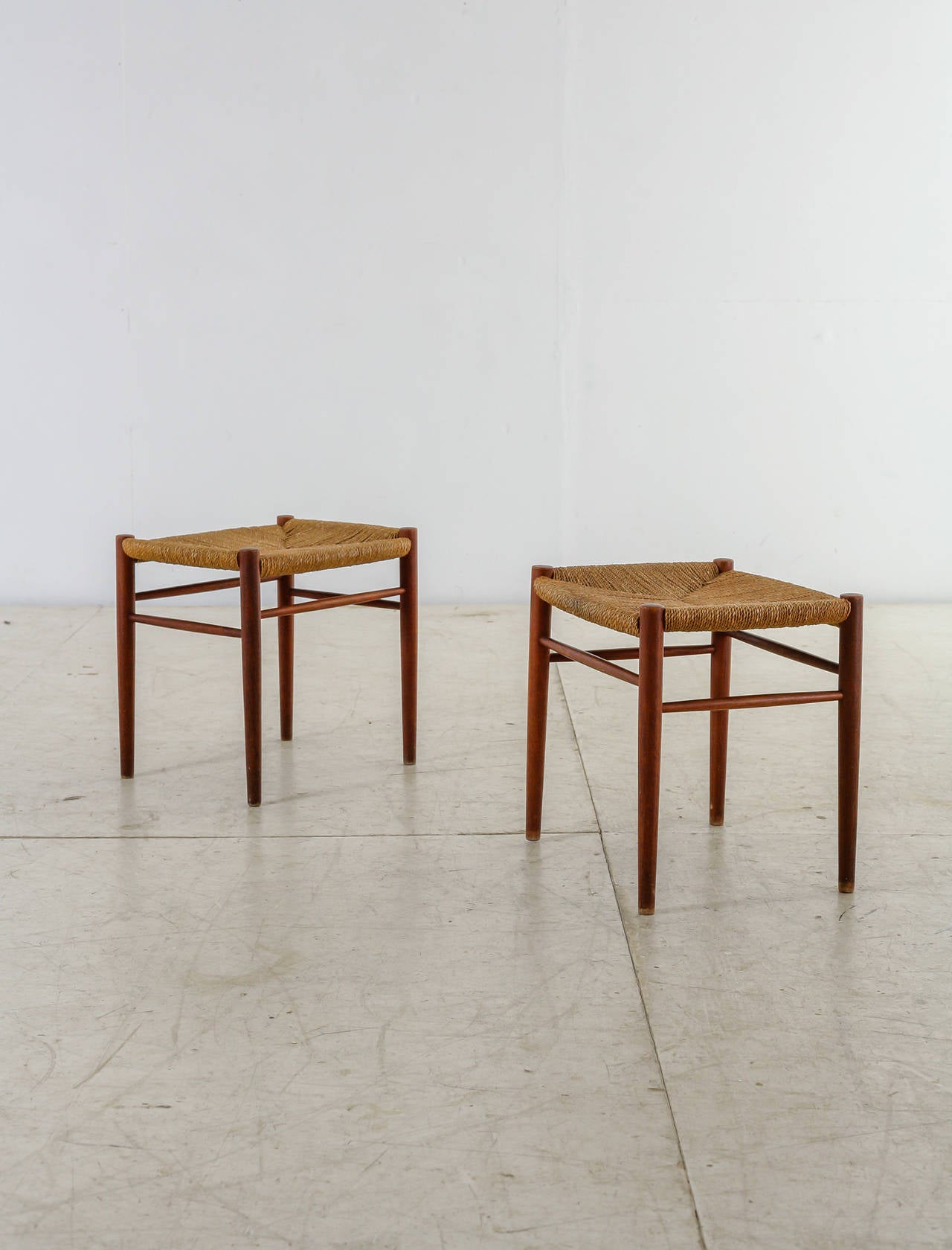 A pair of teak stools by Peter Hvidt & Orla Mølgaard-Nielsen for Søborg Møbelfabrik. The stools have a woven papercord seating, which is in a great condition.