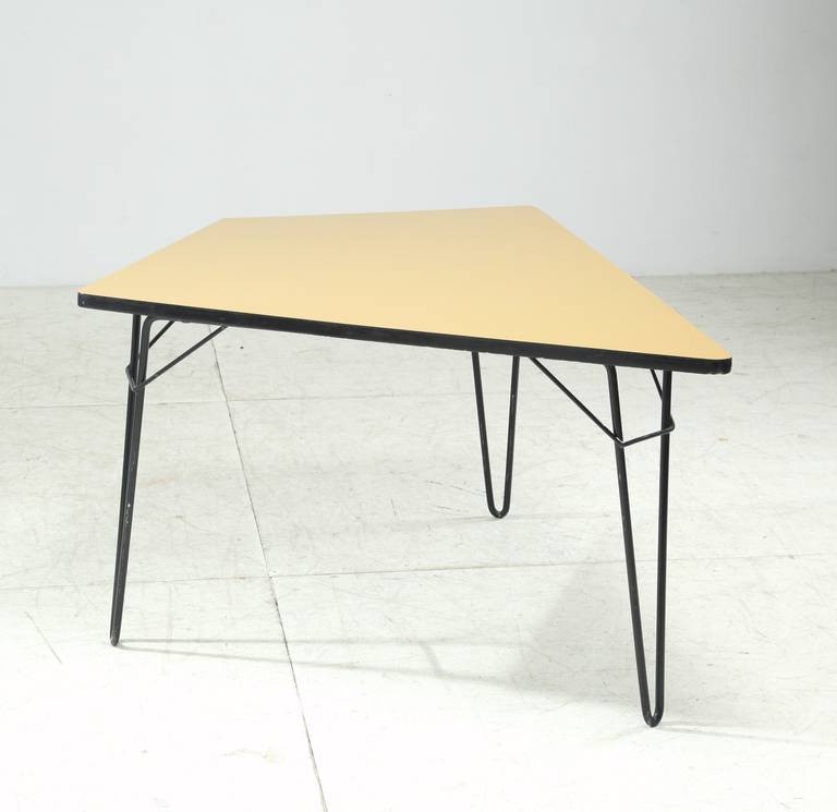 This table is shaped like a part of a tangram puzzle and has a beautiful dark yellow formica top. Suitable as kitchen table, small dining or working table.