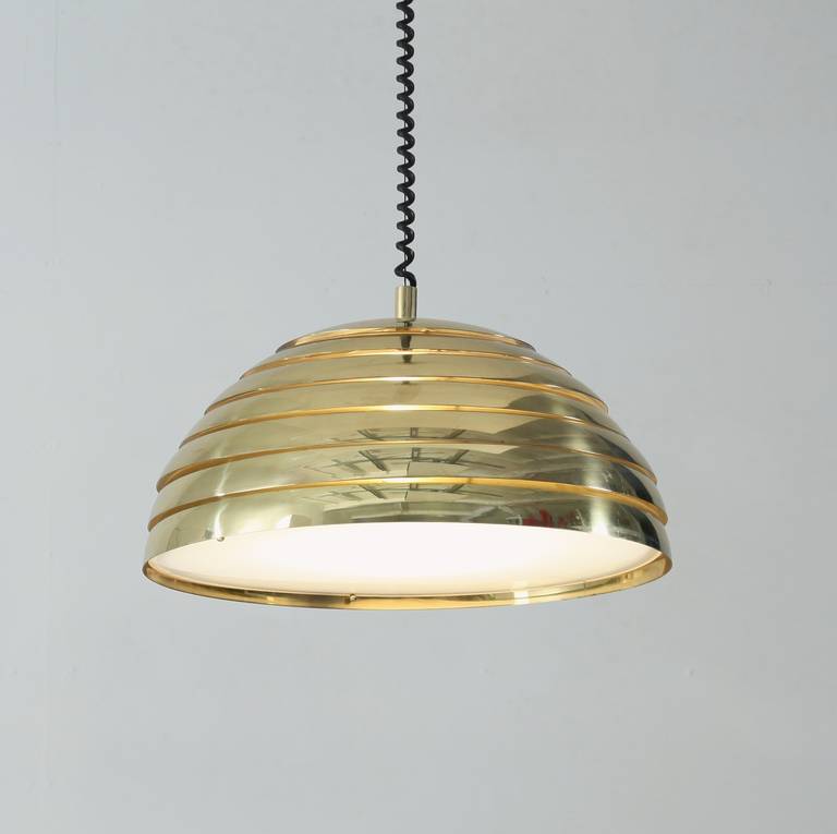A beautiful, large brass pendant lamp from the late 60s/early 70s, Germany. The pendant is made of seven brass rings with a plexiglass diffuser and is in a perfect condition.