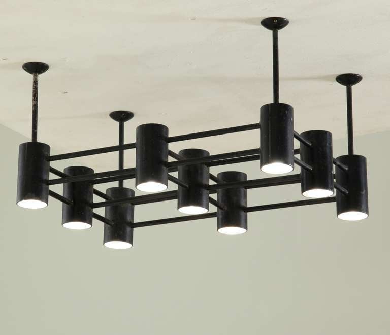 A large and heavy full metal flush mount with 9 cylindrical spotlights hanging from a grid, lacquered black.