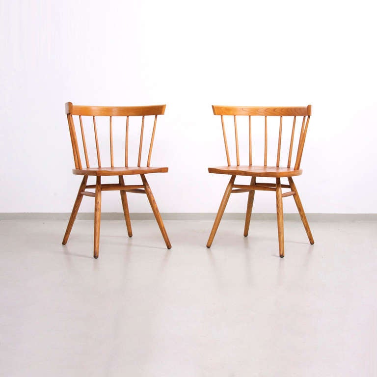 Rare pair of Nakashima straight chairs in excellent vintage condition with no breaks and strong connections and a beautiful patina.