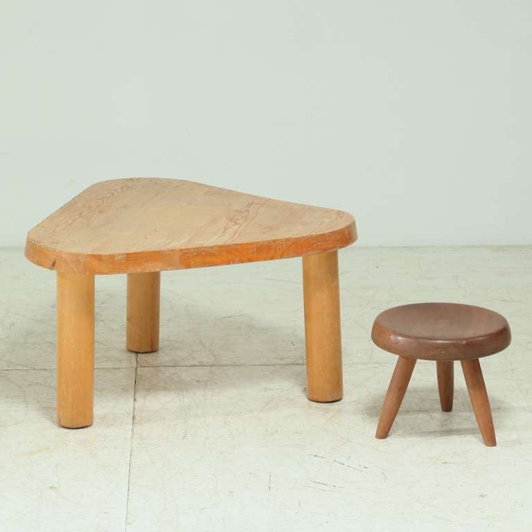 A wooden coffee table with a rounded triangle shape, by Charlotte Perriand. This table was designed for the restaurant of the chalet-hotel Le Doron in the French ski resort Méribel Les Allues, built (1946-48) by architects Paul Grillo and Christian