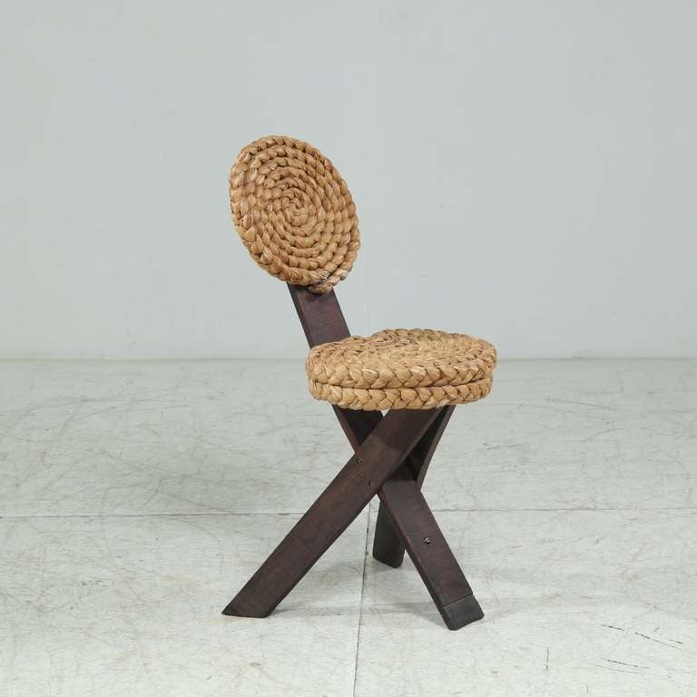 French handcrafted modern chair.
The headrest is connected to the extended center leg and both the backrest and seat are made of rope.

We have a matching stool available.