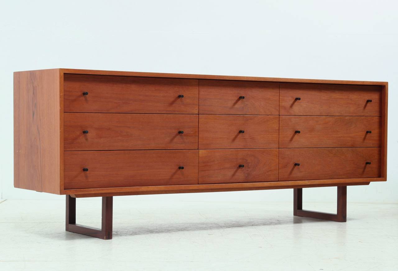 Chest of drawers with three times three drawers.
It is a 1960s production of R.S. Associates, Montreal, Canada and in a very good condition. 

We like the patina on the top, but when desired by the client this can be cleaned in our atelier on our