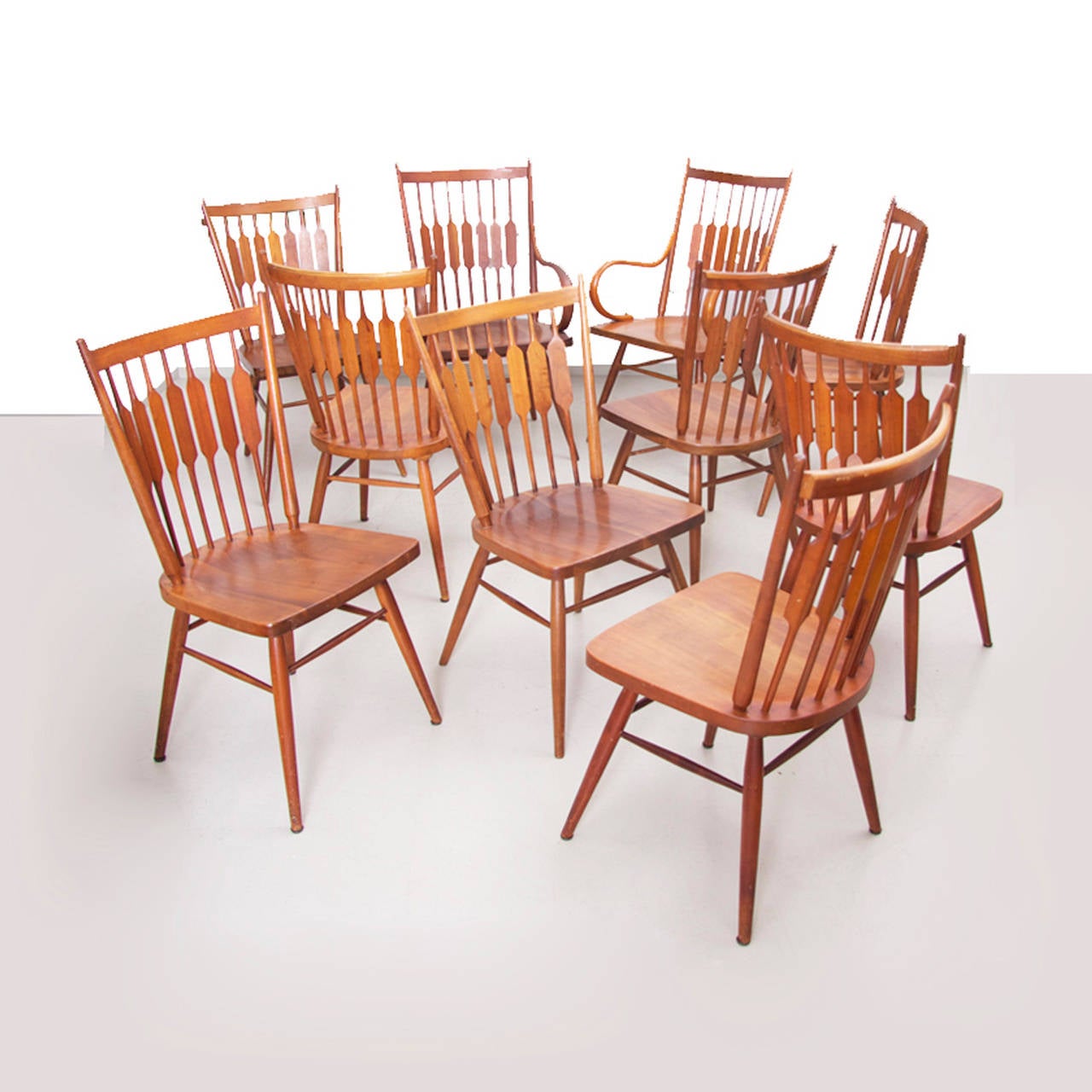 Rare set of ten Kipp Stewart chairs. Eight side and two armchairs in solid walnut by Drexel.
