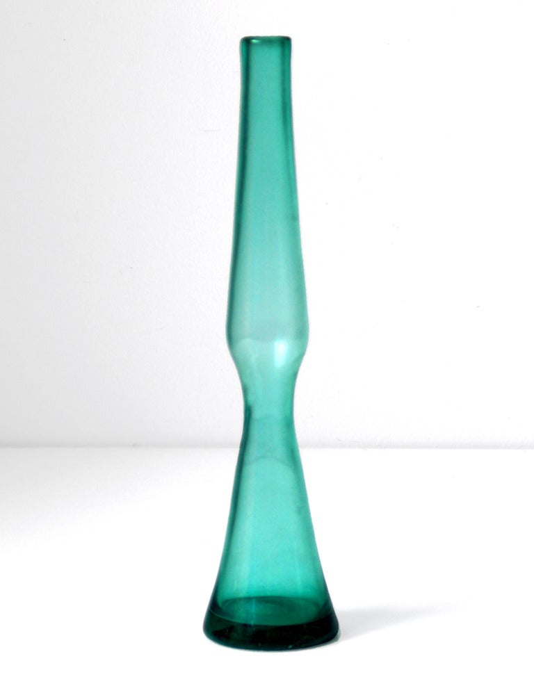Small, narrow rocket-like vase with conical base, designed by Wayne Husted in 1960, made for 2 years only.
Design #6025 in Sea Green, pictured in the 1960 catalog on page twelve http://www.blenkoarchive.org/blenko_catalog_1960.htm
Signed on the