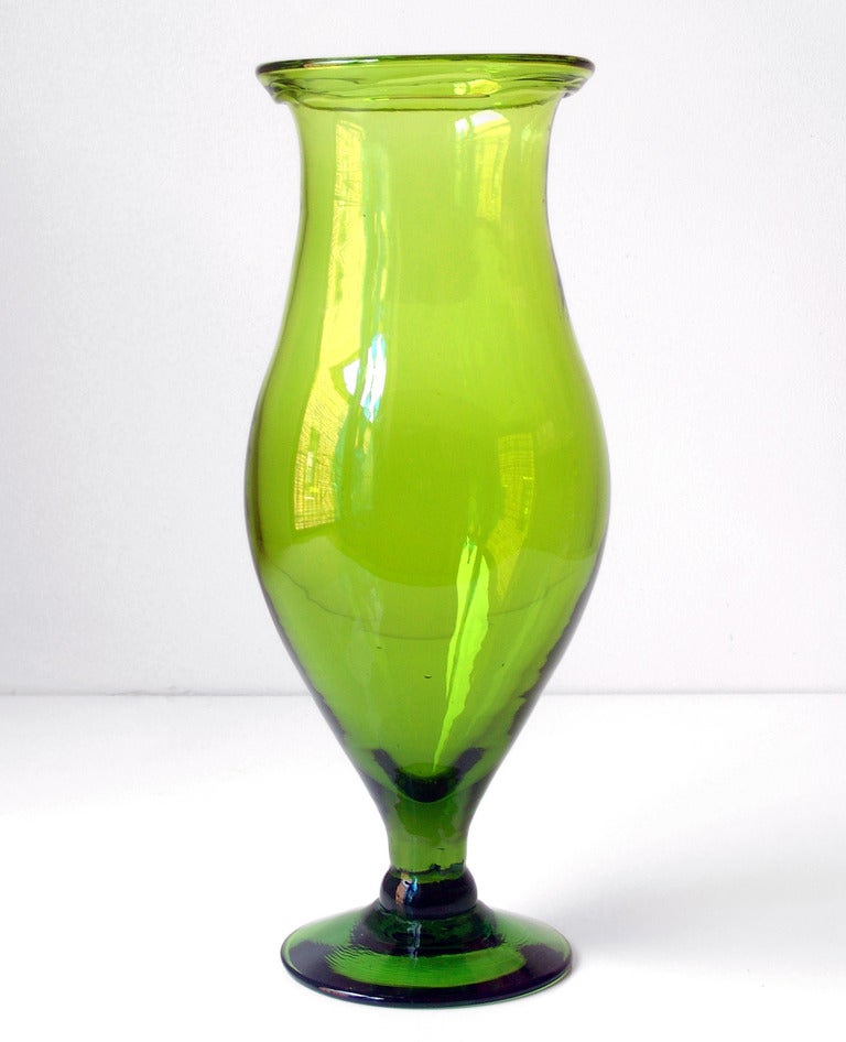 Large footed vase with folded rim, designed by Joel Philip Myers in 1965, made for 1 year only.
Design #6524L in Olive Green, pictured in the 1965 catalog.

___

All our glass is vintage mid-20thC hand blown art glass. Items are guaranteed to