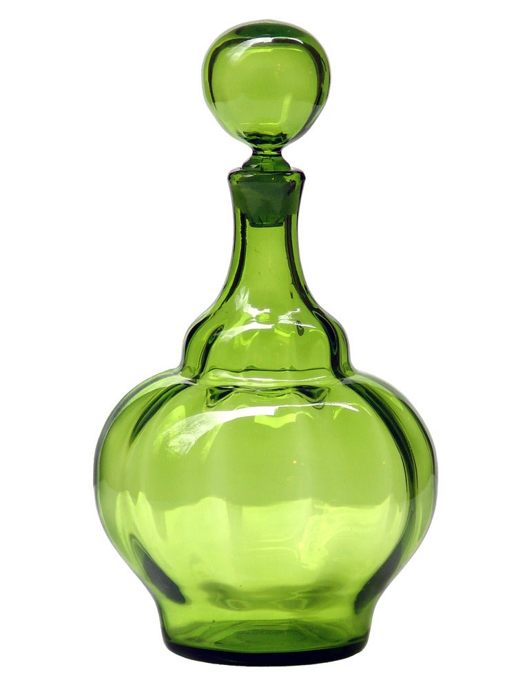 Decanter with ball stopper, designed by Joel Philip Myers in 1969.
Design #6935 in Olive Green, pictured in the 1969 catalog.

___

All our glass is vintage mid-20thC hand blown art glass. Items are guaranteed to be authentic, with certificates