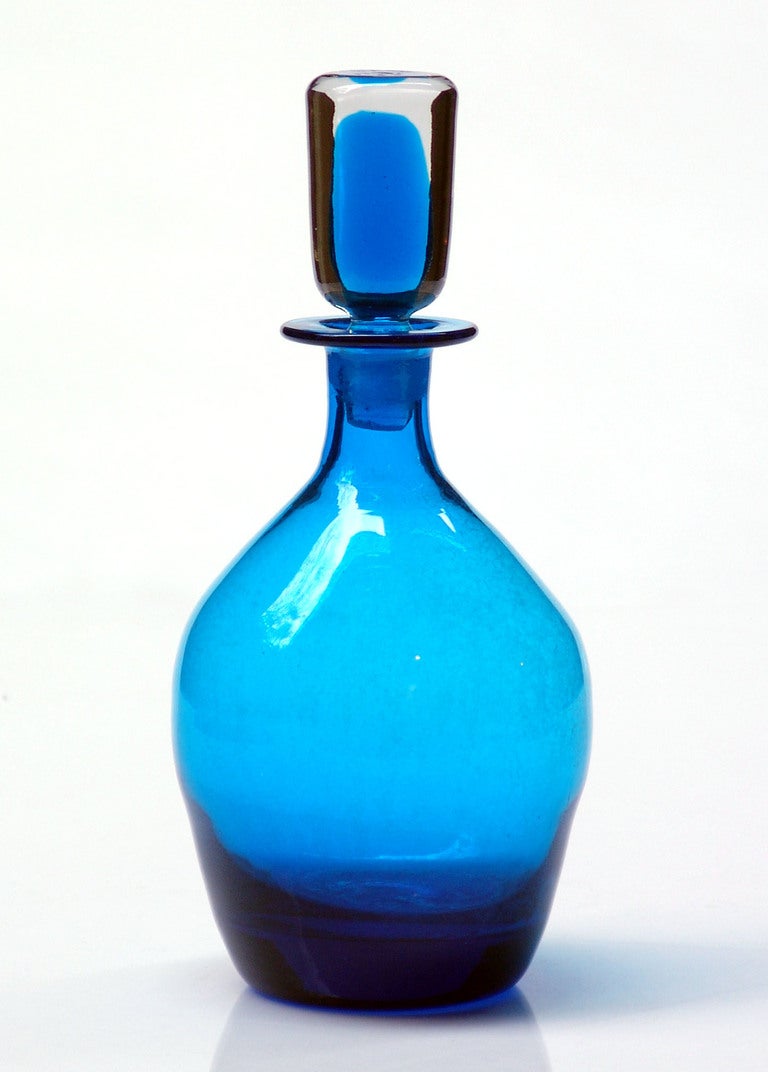 (Items also available individually, please email to inquire.)

LEFT: ovoid decanter with cylindrical sommerso stopper, designed by John Nickerson in 1973. Design #7320 in Turquoise, pictured in the 1973 catalog.
Measures 12.25 inches tall x 5.5