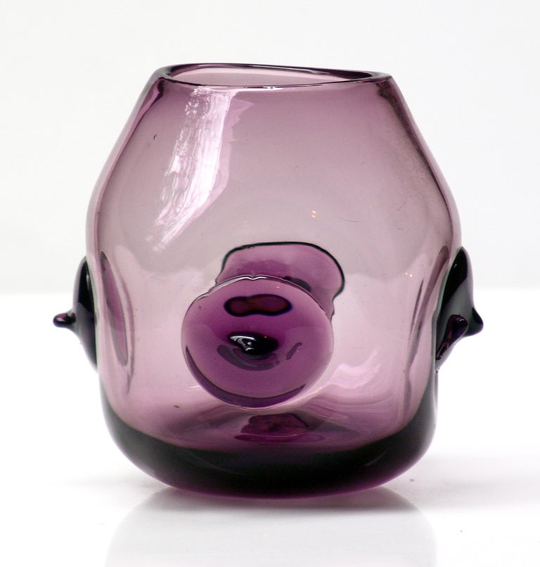 slightly squared teardrop bodied vase with four applied glass rosettes on each side, designed by Wayne Husted in 1959, made for 2 years only.
Design #5940 in Lilac, pictured in the 1959 catalog on the fourth color plate