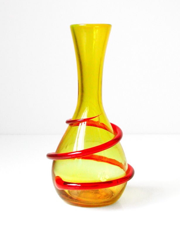 Lemon yellow teardrop shaped vase with red spiral coil wrapped around body, designed by Joel Philip Myers in 1968, made for 2 years only.
Design #6817LT in Lemon and Tangerine, pictured in the 1968 catalog.

___

All our glass is vintage