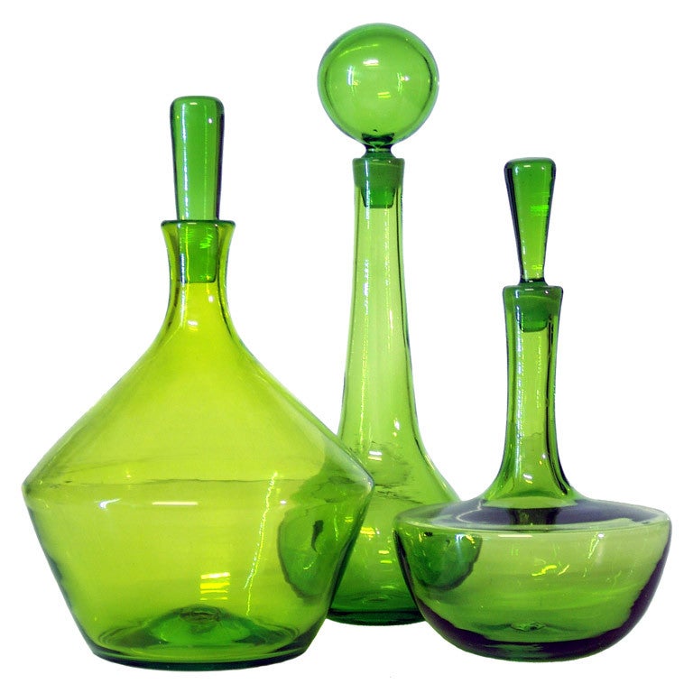 A trio of vintage Olive Green decanters by the Blenko Glass Co.