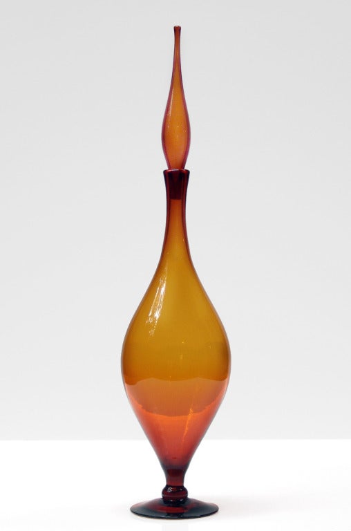 Dramatic and large footed decanter with wide ovoid flame shaped body and flame stopper, designed by Joel Philip Myers in 1965, made for 1 year only.
Design #6528L in Honey, pictured in the 1965 catalog.

___

All our glass is vintage mid-20thC