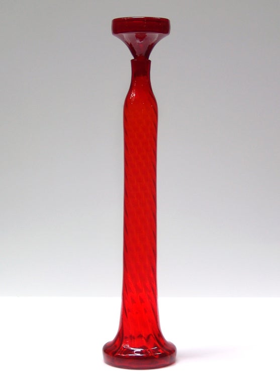 Tall thin cylindrical optic rib architectural scale decanter with flared base and stopper, designed by Wayne Husted in 1962.
Design #6231 in Tangerine, pictured in the 1962 catalog.