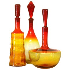 A trio of Tangerine decanters by Joel Philip Myers for Blenko