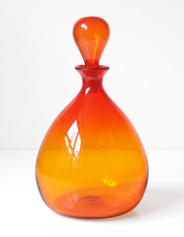 ____

(Items shown in groupings are also available individually, please email to inquire.)

A grouping of three Tangerine colored vintage glass designs produced by the Blenko Glass Company.

LEFT: Decanter #649, balloon shaped decanter with