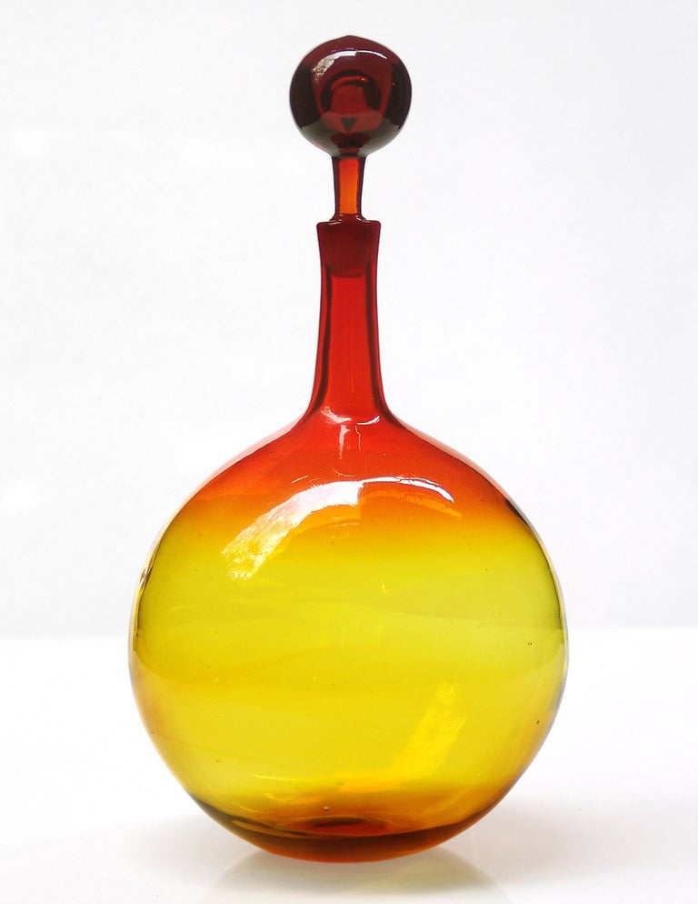 spherical decanter with tall thin neck and ball stopper, designed by Joel Philip Myers in 1965, made for 2 years only.
Design #6533 in Tangerine, pictured in the 1965 catalog.

___

All our glass is vintage mid-20thC hand blown art glass. Items are