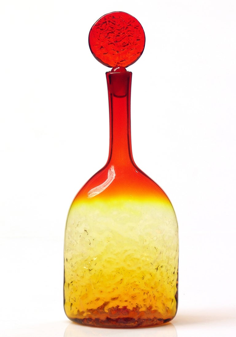 From the coral texture series, flattened or elliptical bodied (axial view) decanter with lollipop stopper , designed by Joel Philip Myers in 1967, made for 1 year only.

Design #6728 in Tangerine, pictured in the 1967 catalog.

___

All our glass is