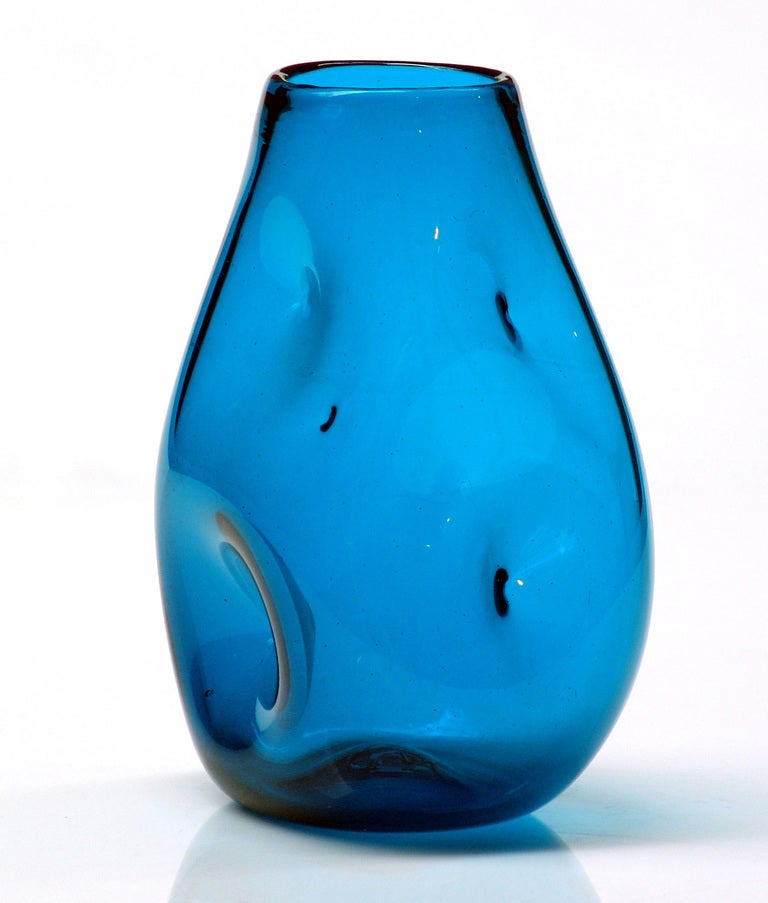 Small dimpled or indented ovoid vase, designed by Winslow Anderson in 1950.
Design #921M in Teal, pictured in the 1950 catalog http://www.blenkoarchive.org/blenko_catalog_1950.htm

___

All our glass is vintage mid-20thC hand blown art glass. Items