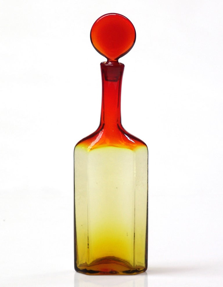 Narrow decanter with hexagonal axial view, elongated neck and lollipop stopper, designed by Joel Philip Myers in 1967, made for 1 year only.
Design #6727 in Tangerine, pictured in the 1967 catalog.

___

All our glass is vintage mid-20thC hand blown