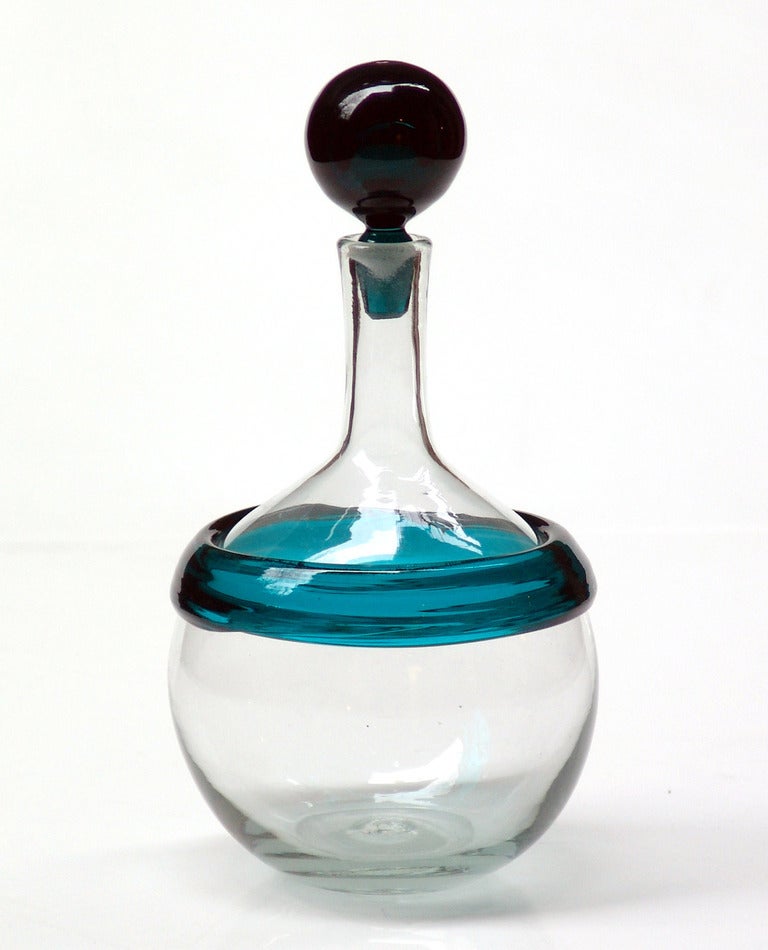 Special commission (non-catalog design) decanter for Gump's of San Fransisco. Ball shaped body with with applied Peacock color ring and ball stopper, designed by Joel Philip Myers in 1964, made in this color for 1 year only.

___

All our glass is