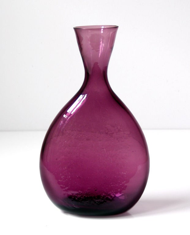 _____

(Items also available individually, please email to inquire.)

LEFT: flattened round bottle-form vase with rough polished top, designed by Winslow Anderson in 1951, made for 2 years only.
Design #959 in Amethyst, pictured in the 1951