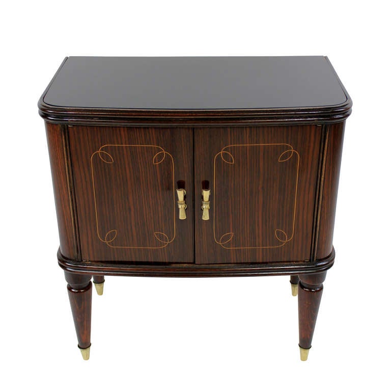 A pair of Italian night stands in rosewood, with black glass inset tops and elegant brass fittings.