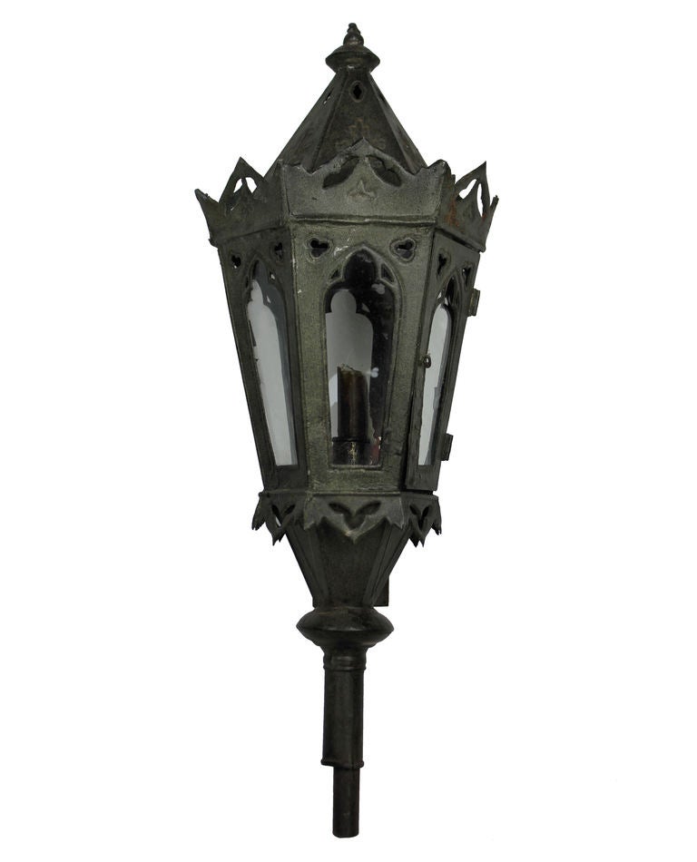 A set of four Venetian wall lanterns in dark green tole. Formerly processional lanterns, they have had later brackets made. Not electrified.
