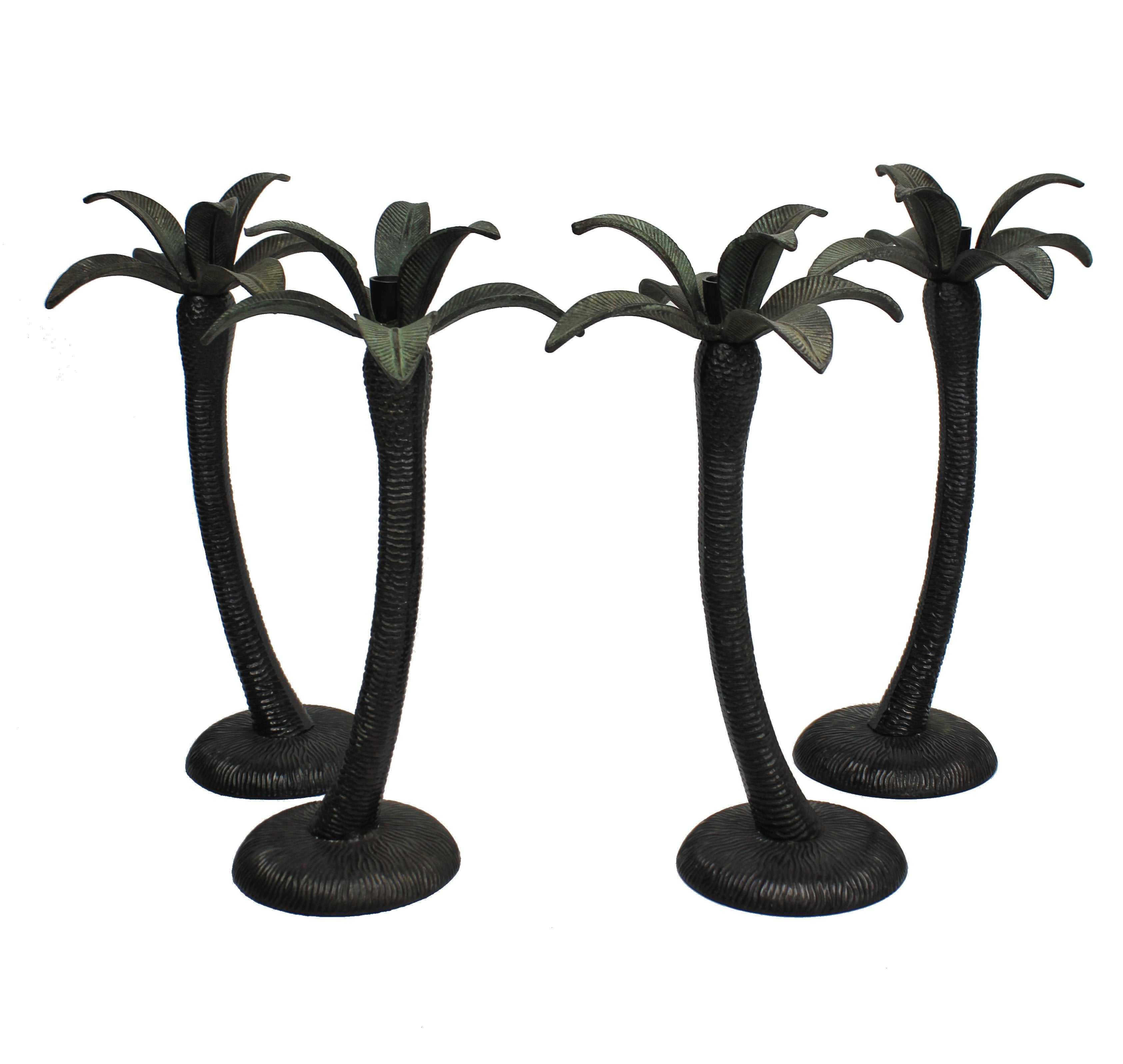 A Set Of Four Patinated Bronze Palm Tree Candlesticks