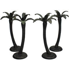A Set Of Four Patinated Bronze Palm Tree Candlesticks
