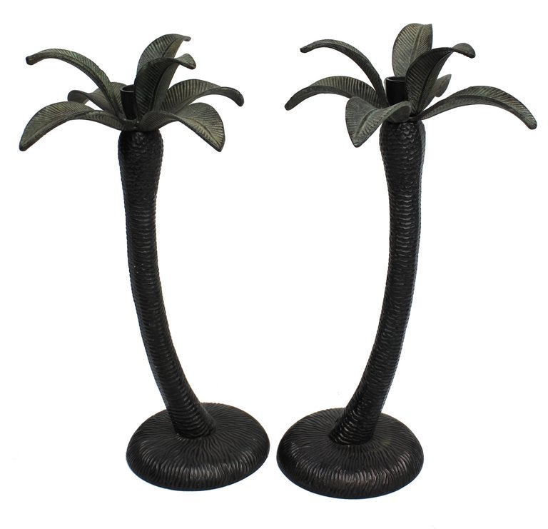 A set of four English patinated bronze candlesticks in the form of palm trees.
