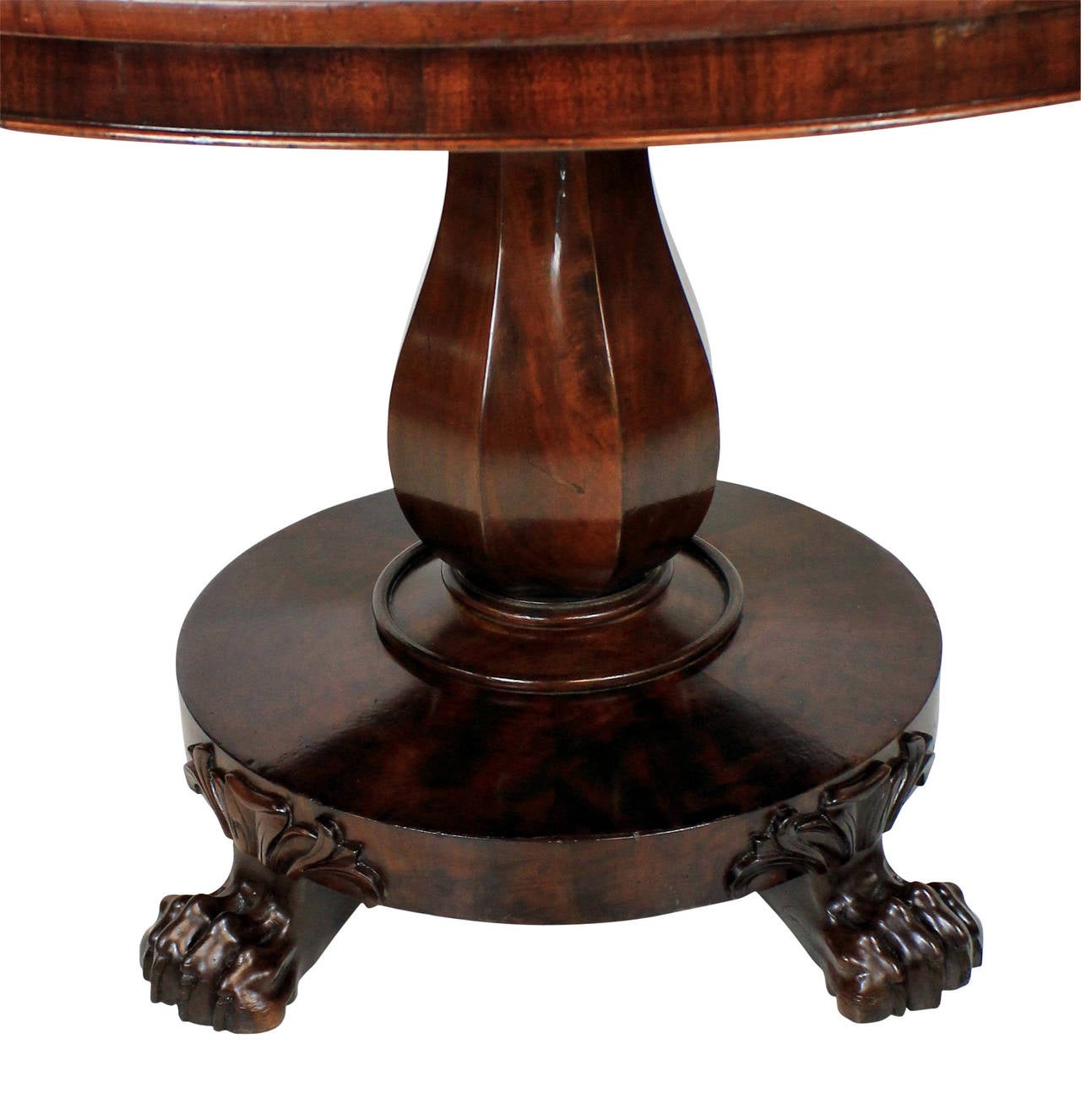 An Irish William IV mahogany centre table, with a baluster central stem and attractive claw feet. It has its original sunken casters.