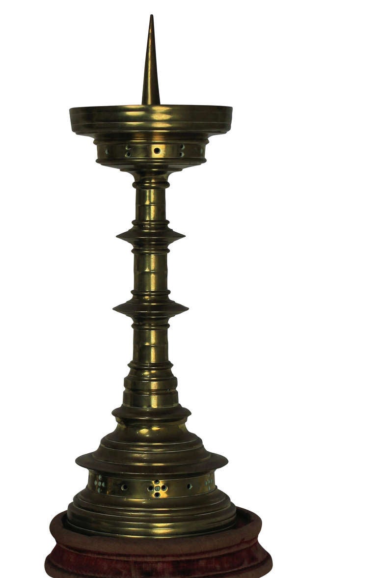 A pair of Flemish late 17th Century pricket sticks in brass, on velvet bases.
  