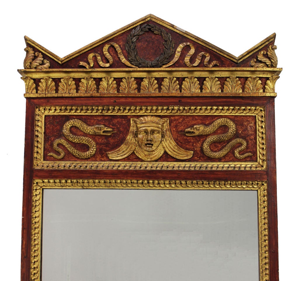 An Italian Neo-Classical mirror, carved and water gilded on a faux tortoiseshell background with carved and water gilded Egyptian & Ancient Greek Design.