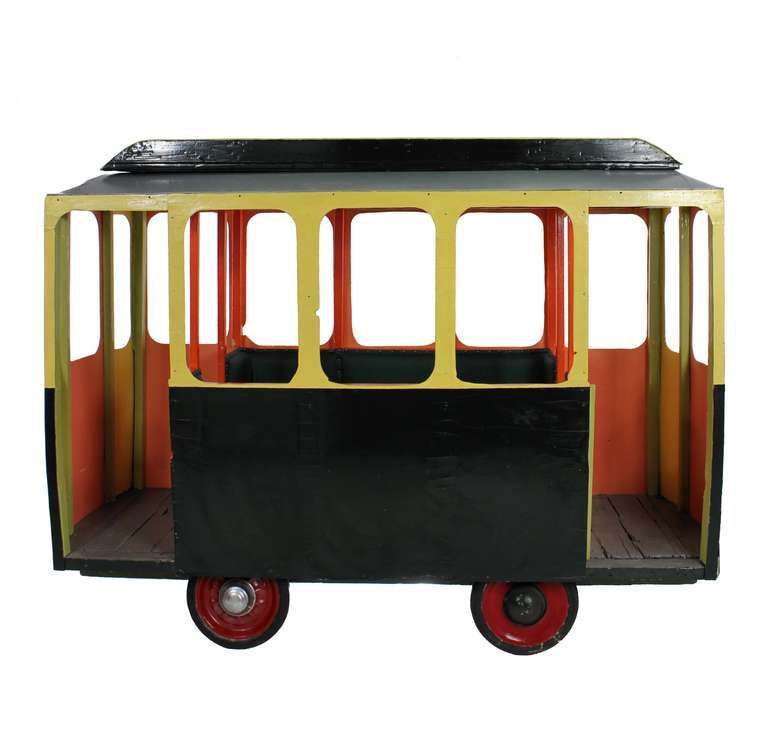 A French children's fairground tram with green leather interior, seating six. Re-painted in its original colours and fully mobile on four articulated wheels.
