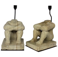 A Pair Of Carved Limestone Seated Male Figures As Lamps