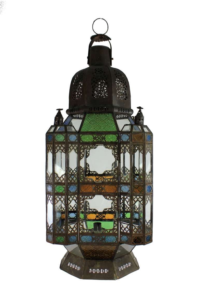 A large Moroccan lantern of traditional form with patterned stained glass panels.

Please note this item is subject to VAT