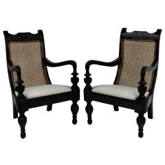 A Pair Of 1920's Colonial Ebonized Hardwood Armchairs