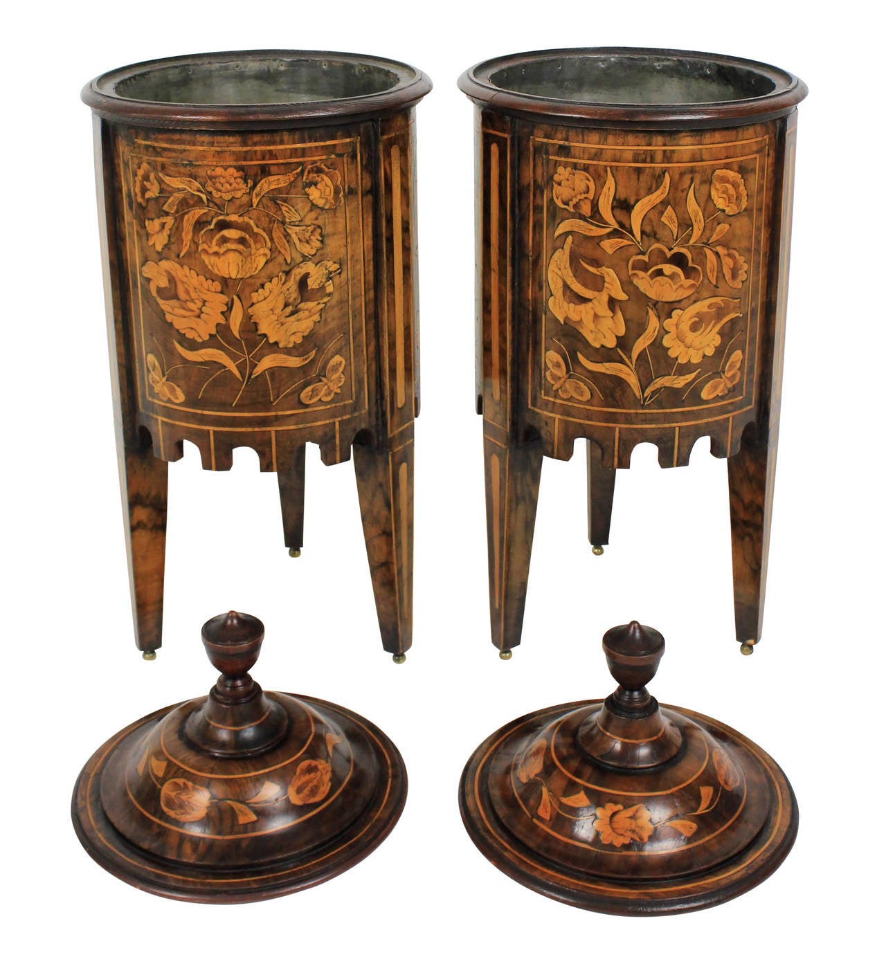 A pair of Dutch wine coolers of exquisite quality. inlaid depicting flowers and butterlies, in tulip wood and walnut. Lead lined, with covers and on brass ball feet.
